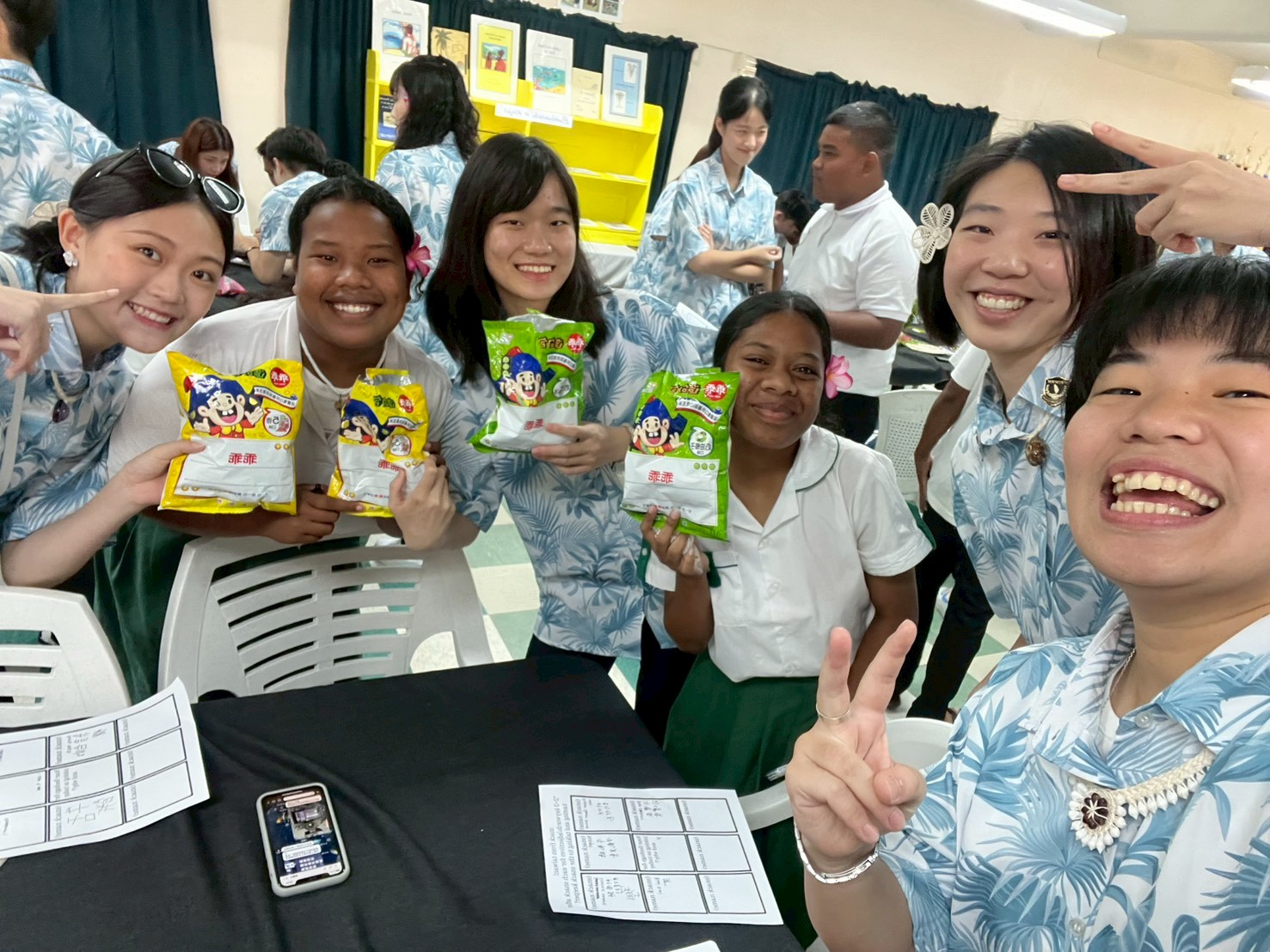 Youth ambassadors exchange cultures with Marshallese high school students by sharing snacks; Ting-En Chang is first from the right.