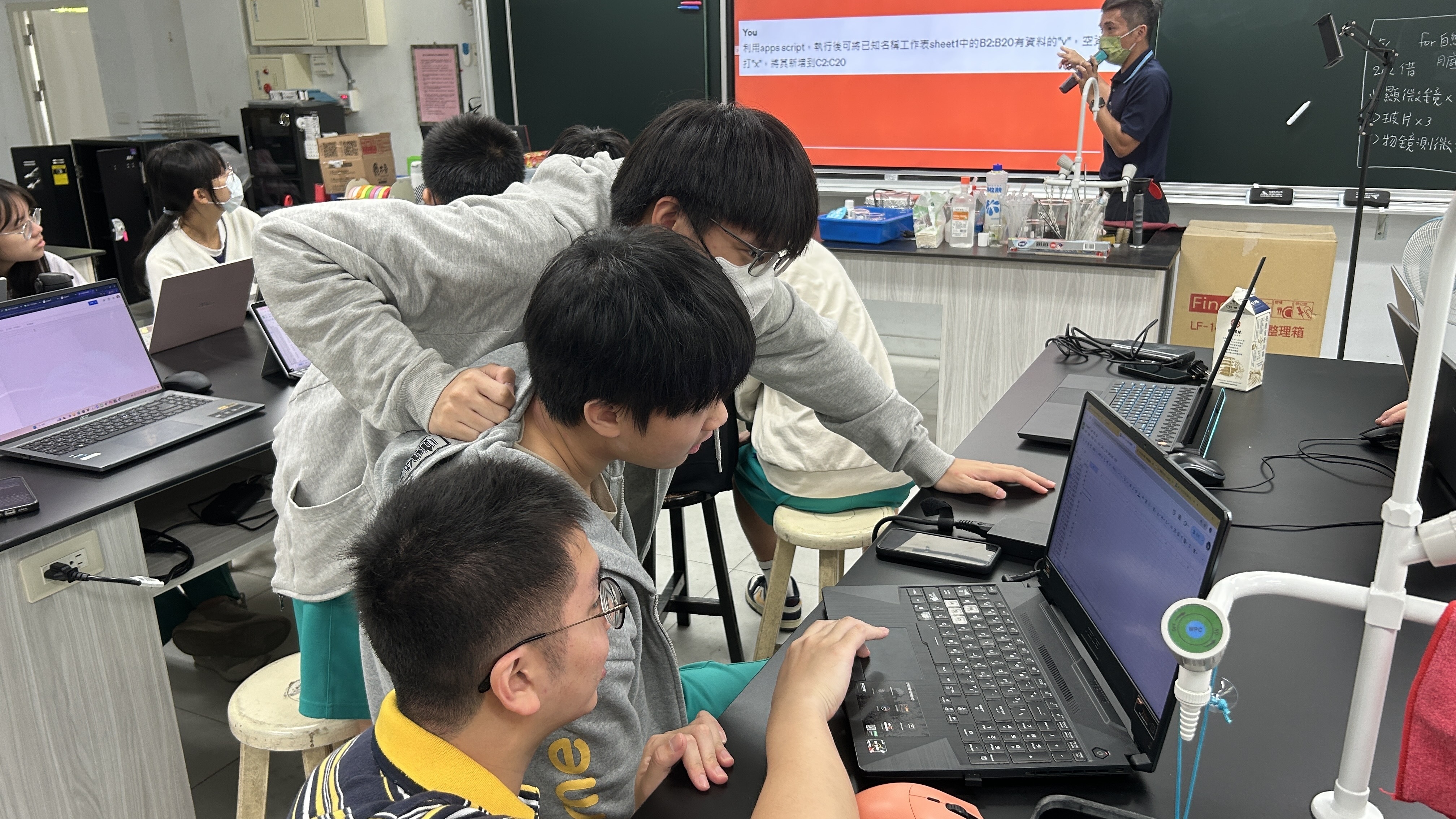 Students collaborate within groups to solve tasks together.