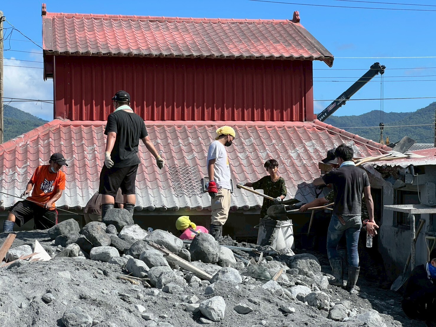 Taiwan Tech students removing mud and debris.
