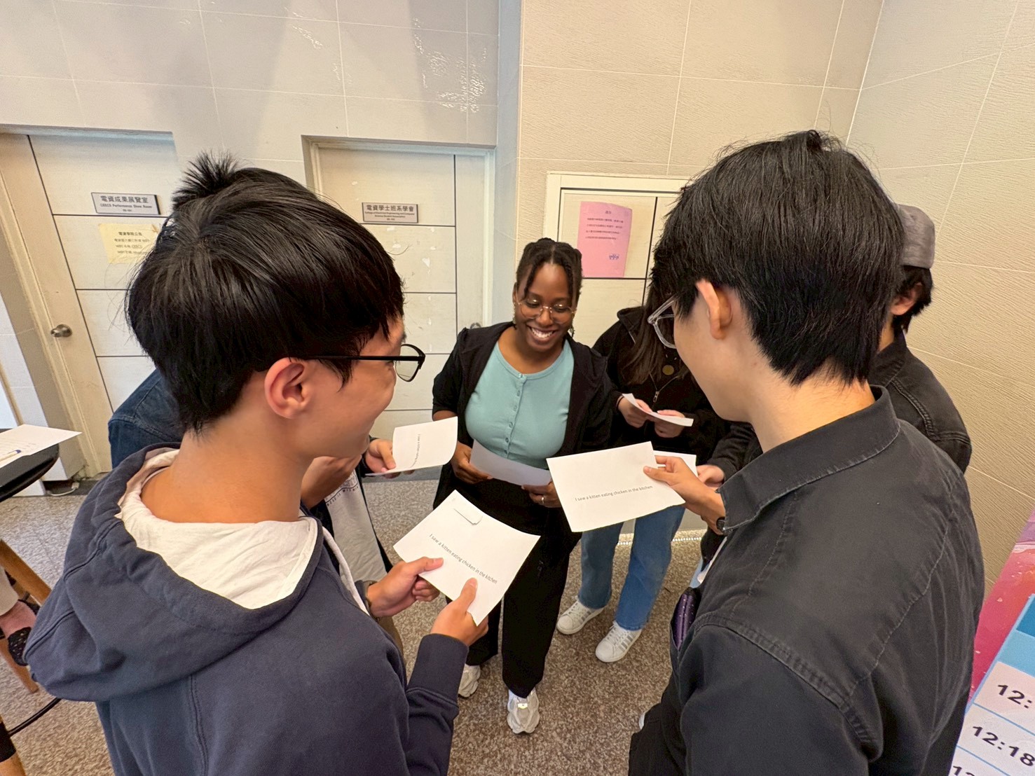 Fulbright instructors guiding participants in tongue twister practice.