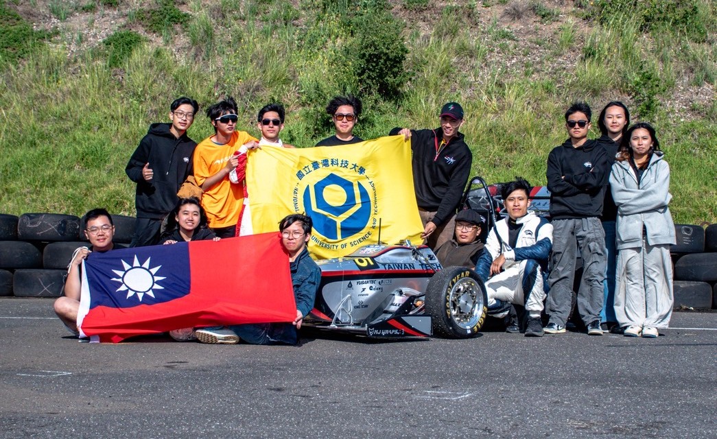 Group photo of the racing team members during the competition.