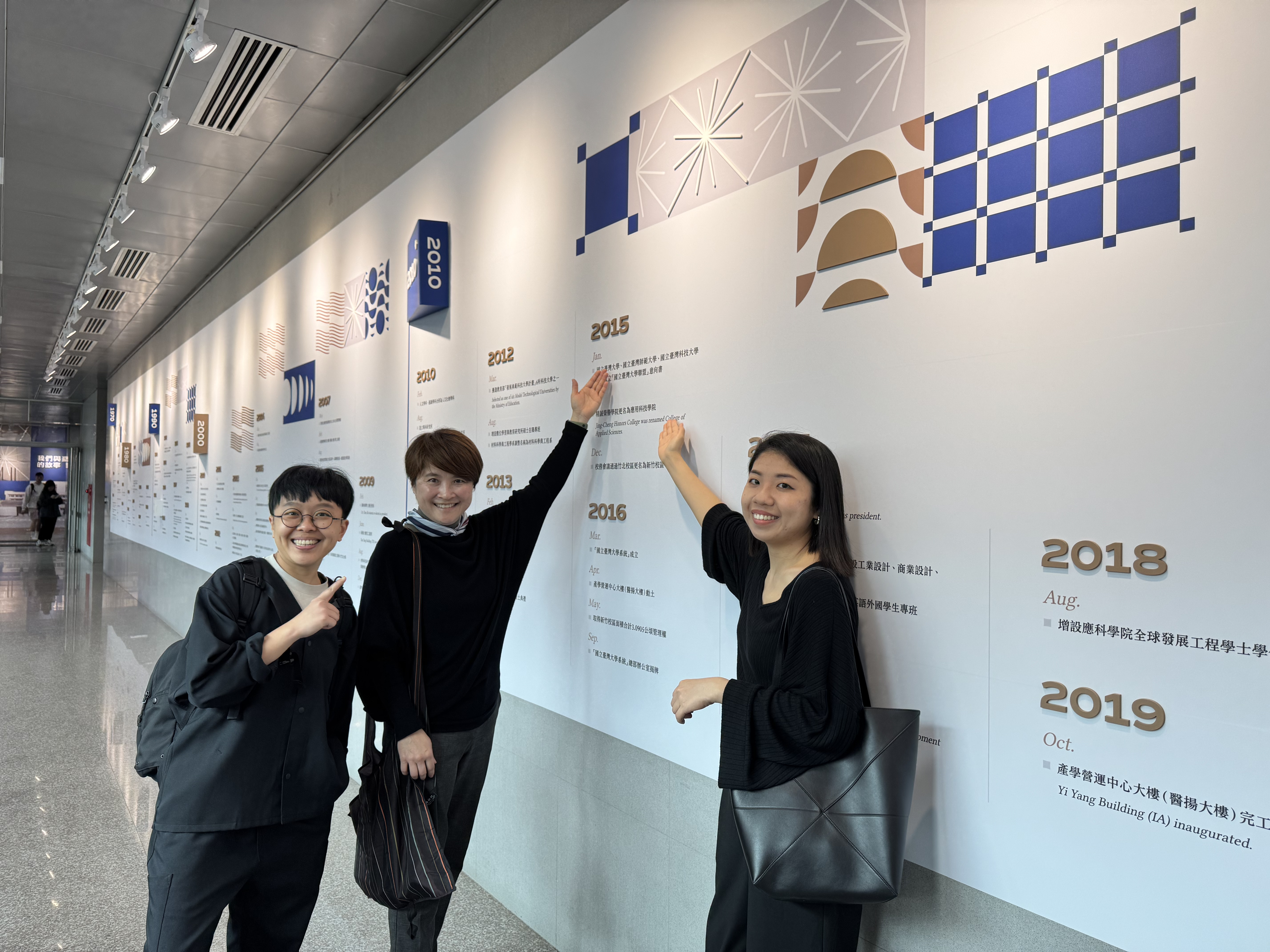 Alumni Yi-Zhen Huang (right 1) and Pei-Hsuan Kuan (left 1) assisted in organizing Taiwan Tech’s 50-year history, visually presenting the milestones to make the information more intuitive and accessible.