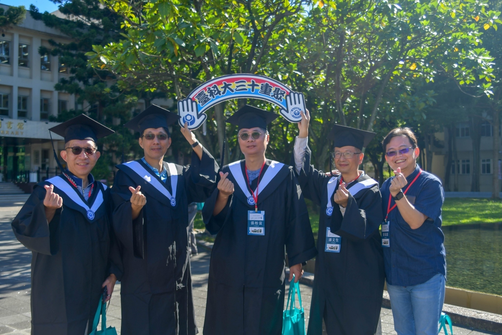 Wearing graduation gowns again